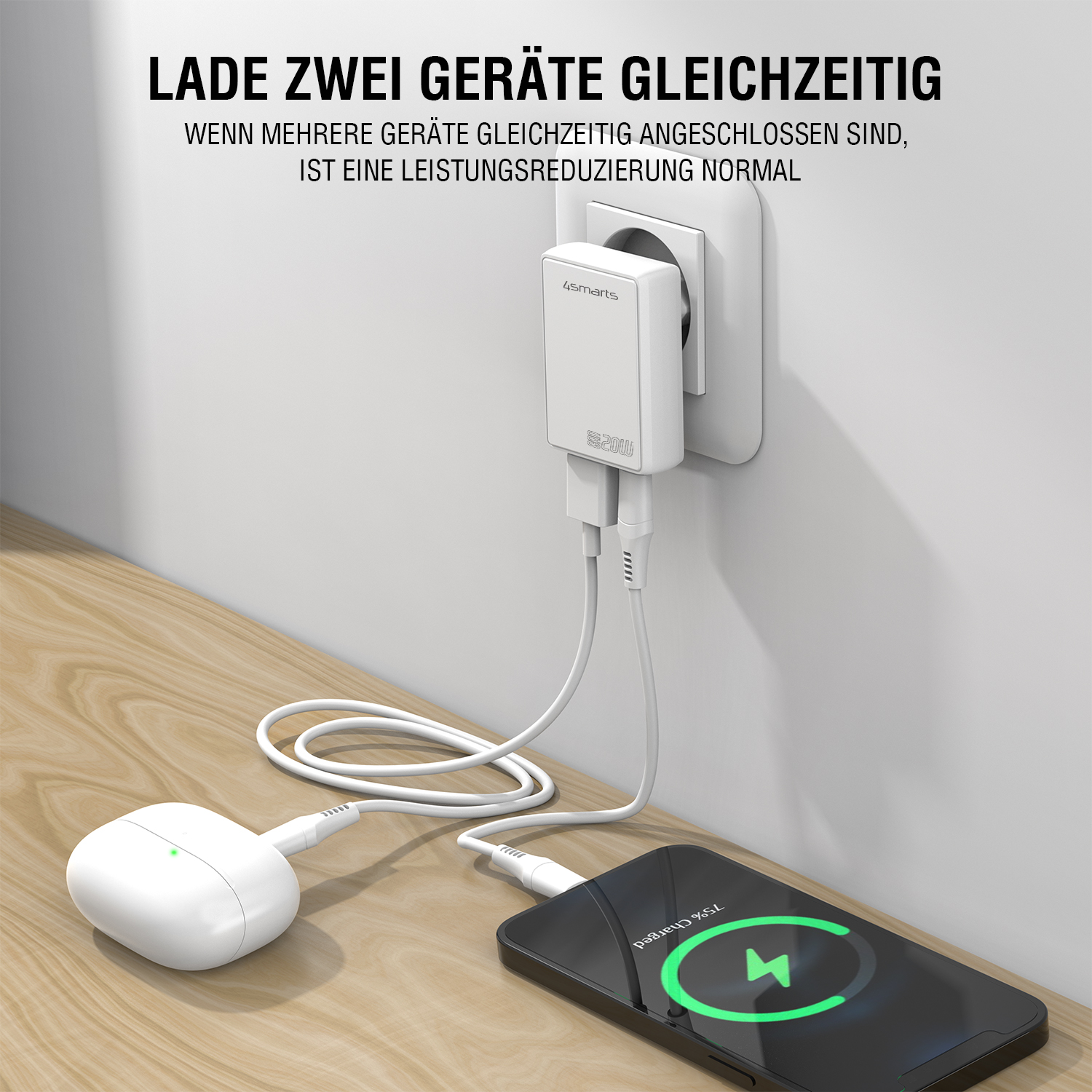 4smarts USB-C Ladegerät in der Steckdose, lädt gleichzeitig ein Laptop und kabellose Kopfhörer, mit der Hinweisbeschriftung 'Lade zwei Geräte gleichzeitig'.“
