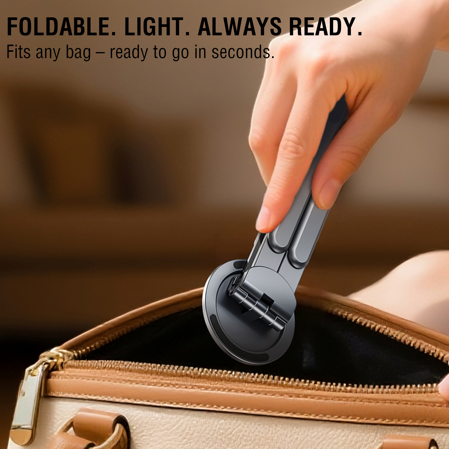 Hand placing the compact, folded device stand into a handbag – lightweight and portable.